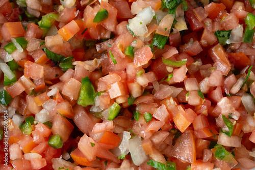 A top down view of a pile of pico de gallo salsa, as a background.