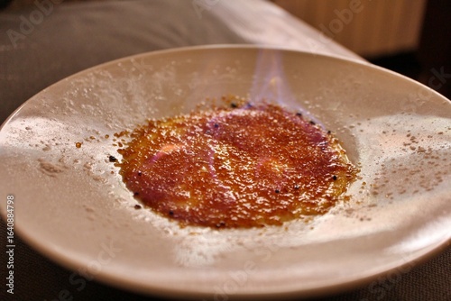 Obraz na plátně French dessert: crème brûlée (being flambéed) in Venice, Italy