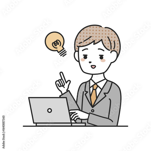 パソコンの前でひらめくスーツを着た男性