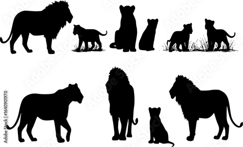Silhouettes of lions and lion cubs outdoors
