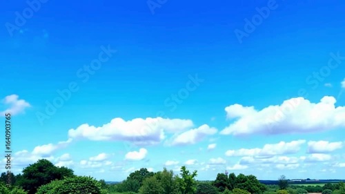 Fluffy White Clouds Floating in Bright Sky