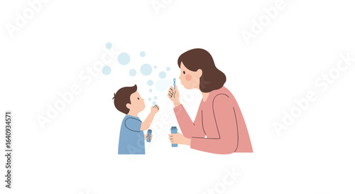 Mother blowing bubbles with her son, blue bubbles float in air