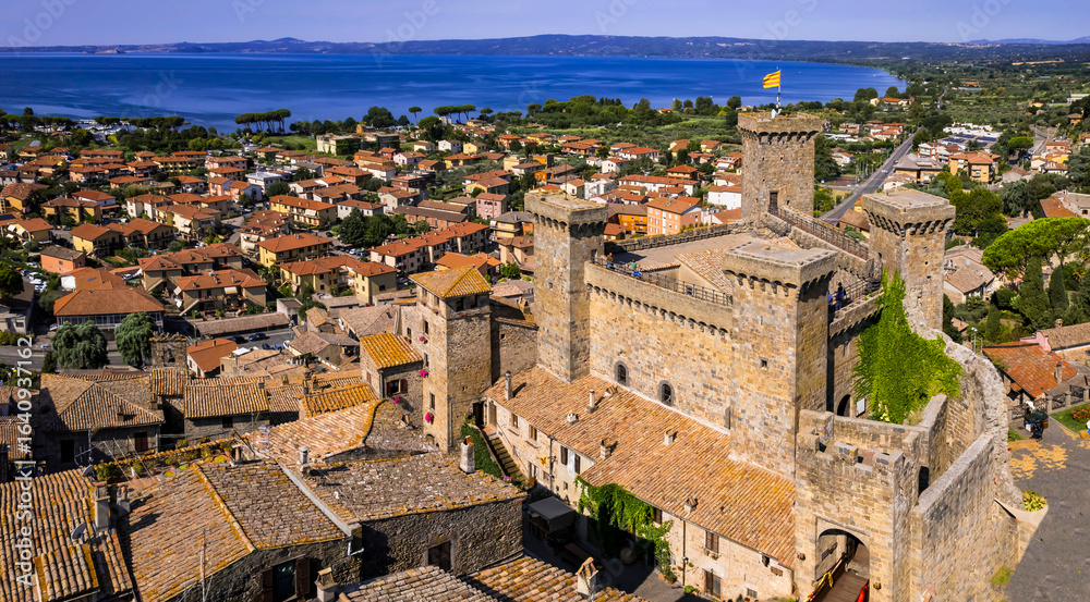 Obraz premium Italy tourism and landmarks. Scenic medieval village and castle over Bolsena lake , lago di Bolsena, Viterbo province, Lazio region, aerial drone view