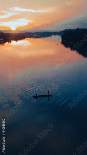 Sunrise Over River with Traditional Fishermen Silhouette.