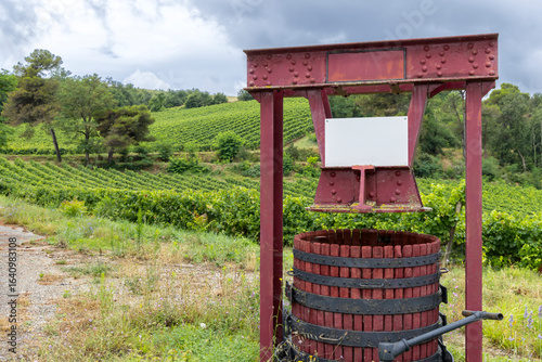Εκτύπωση καμβά Traditional wine press standing in the vineyards of Pieusse, France, under cloud