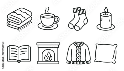 Cozy home elements: blanket, coffee, socks, candle, book, fireplace, sweater, pillow