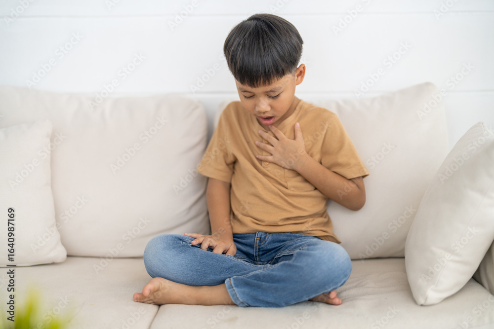 Asian boy with chest pain suffering from heart attack, health and medical, heart health, heart attack, world heart day, cardiovascular disease.insurance and hospital concept Asian boy with chest pain suffering from heart attack, health and medical, heart health, heart attack, world heart day, cardiovascular disease.insurance and hospital concept