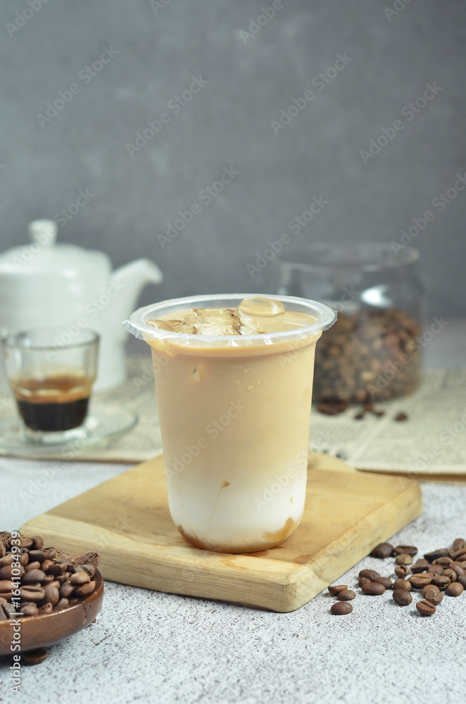 Ice coffee in a plastic cup with brown sugar and ice cubes and beans Ice coffee in a plastic cup with brown sugar and ice cubes and beans