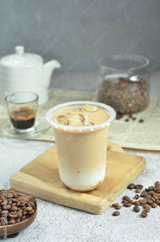 Ice coffee in a plastic cup with brown sugar and ice cubes and beans Ice coffee in a plastic cup with brown sugar and ice cubes and beans