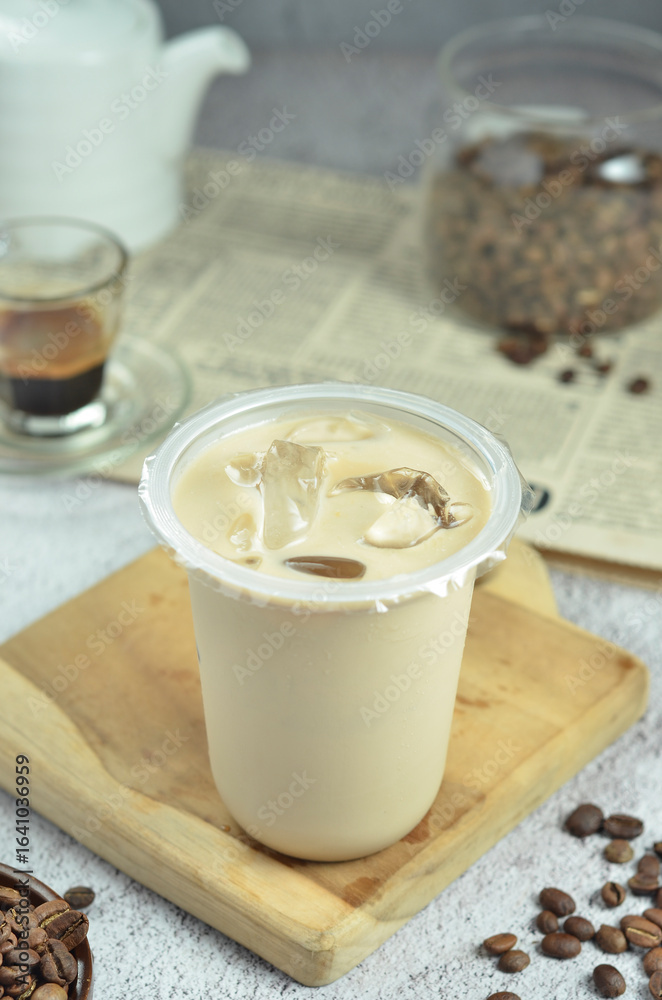 Ice coffee in a plastic cup with brown sugar and ice cubes and beans Ice coffee in a plastic cup with brown sugar and ice cubes and beans
