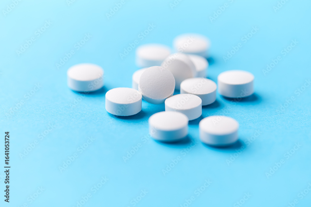 Hyaluronic acid tablets. Hyaluronic acid helps skin stretch and flex and reduces skin wrinkles. Bright paper background. Soft focus. Close up. Copy space Hyaluronic acid tablets. Hyaluronic acid helps skin stretch and flex and reduces skin wrinkles. Bright paper background. Soft focus. Close up. Copy space