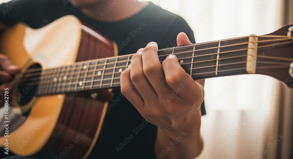 Obraz premium Man playing acoustic guitar close up, hand on fretboard, artistic expression, musical instrument, entertainment