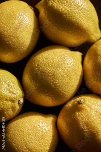 Fresh lemons on dark background captured in detail
