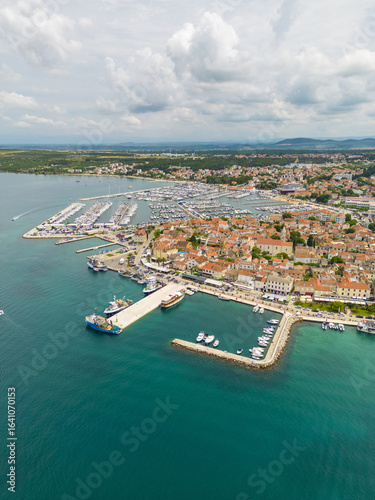 Wallpaper Mural Aerial view of the marina and old town, where terracotta rooftops meet the turquoise Adriatic Sea, Biograd na Moru, Zadar County, Croatia. Torontodigital.ca