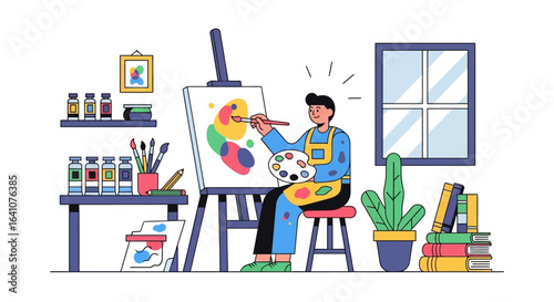 Artist in yellow apron painting abstract colorful shapes on canvas