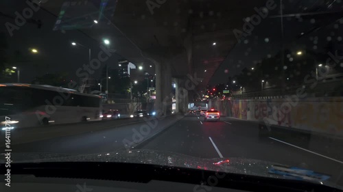 Mexico City, Mexico. Driving a car in the rain at night on the highway in the city.