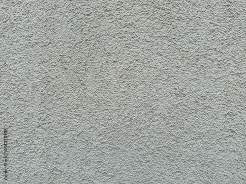 Horizontal light gray plaster wall with rough textured surface. Architectural background close-up, neutral construction material grungy old backdrop for design or copy space