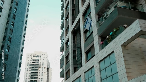 A part of a residential complex, where a single Israeli flag is hanged out from one of the apartments balcony. Ramat Gan, Israel.