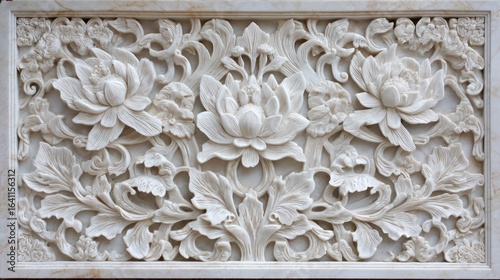 Ornate white marble floral relief carving with swirling vines and detailed petals