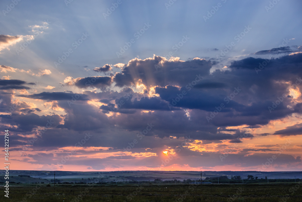 Obraz premium Sunset over fields in rural area of Romania
