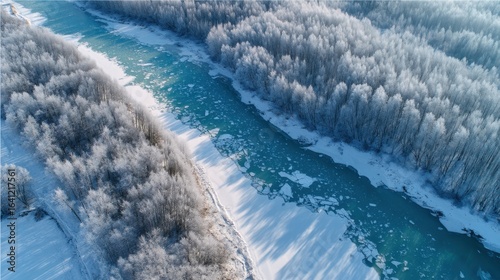Wallpaper Mural Aerial view of a turquoise river with ice floes flowing through a snow-covered winter forest, nature landscape. Torontodigital.ca