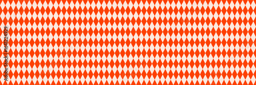 Circus diamond rhombus seamless pattern in orange and cream. Harlequin background vector for retro design, costume, or festive wrapping. Drag to swatches panel to use
