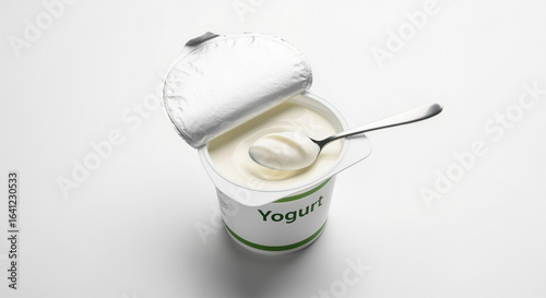 Yogurt cup with spoon creamy dairy product healthy breakfast snack probiotic food nutrition diet eating delicious 100
