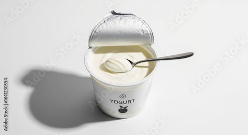 Delicious creamy yogurt in a cup with a spoon healthy snack breakfast food dairy product still life photography