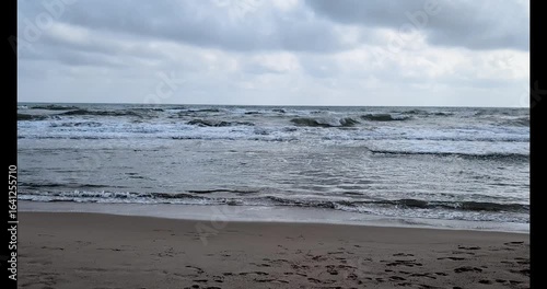 4k video, a view of the Mediterranean Sea from a beach in the province of Valencia on a cloudy summer day.