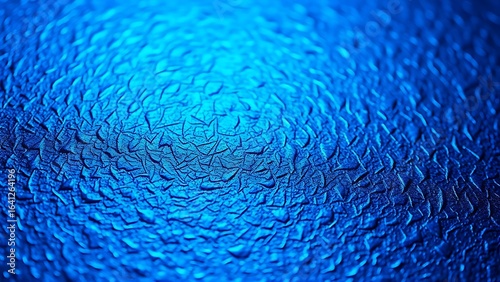 A close-up of a textured metallic surface with a subtle blue hue.