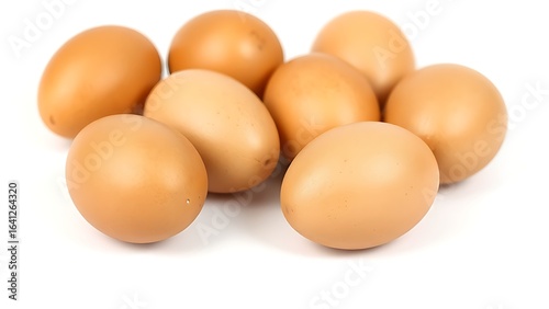 Brown eggs on a white surface, showcasing natural texture and subtle shadows in a minimalist composition.
