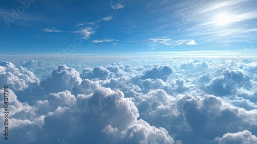 Above the Clouds: Aerial View of Cumulus Clouds Against a Blue Sky with Sunlight