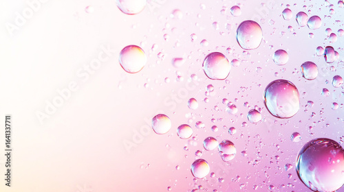 Water droplets on a pink and purple background.