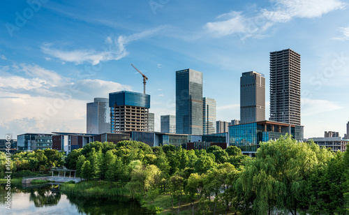 Majestic Urban Skyline Surrounded by Lush Greenery and Tranquil Waters