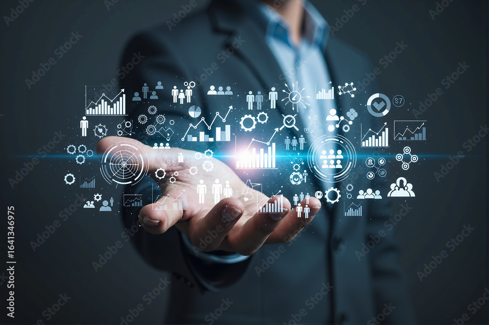 Fototapeta premium Businessman presenting digital interface with business analytics icons and charts