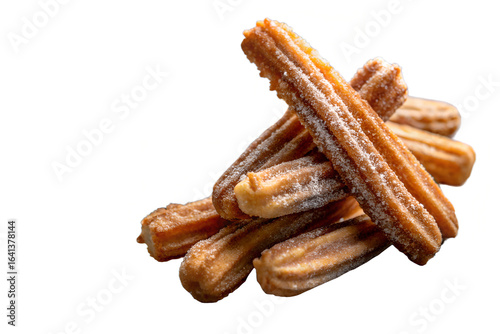 A pile of churros sprinkled with sugar on a white background close up view