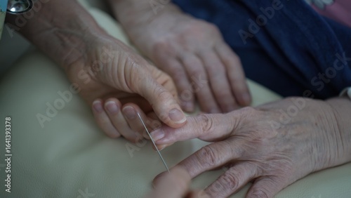 Canvas Print Nurse holds a nail file to shorten the nails of an elderly woman, showing attention to personal care and comfort during a visit that emphasizes nurturing