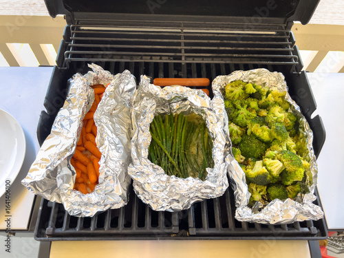 Canvas Print Three Foil Vegetable Packs on Outdoor Grill