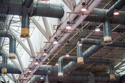 Modern Industrial Ventilation System with Pipes and Lighting in an Urban Setting
