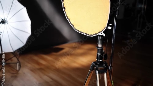Studio Photography Lighting Setup:  A Close-up of a Diffused Light on a Tripod in a Professional Photography Studio.