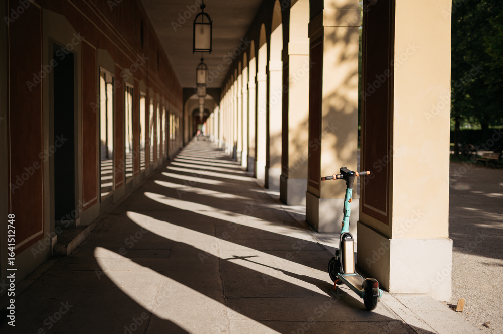 Fototapeta premium Electric Scooter Parked in Historic Hofgarten Arcade, Munich