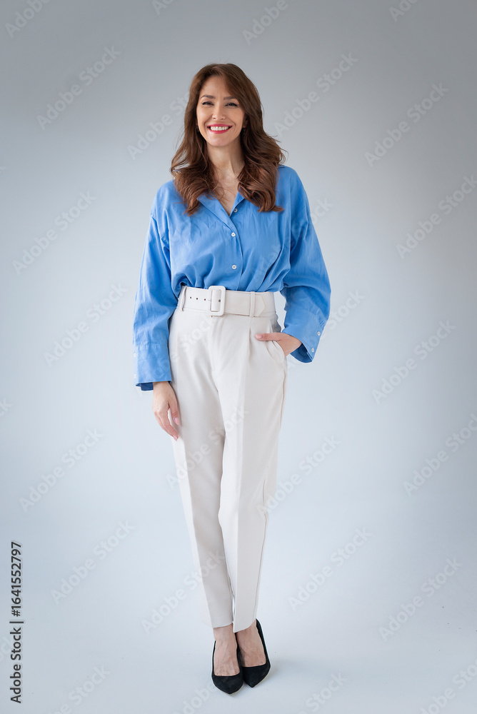 Studio shot of a brunette haired woman standing against isolated background wiht copy space Studio shot of a brunette haired woman standing against isolated background wiht copy space