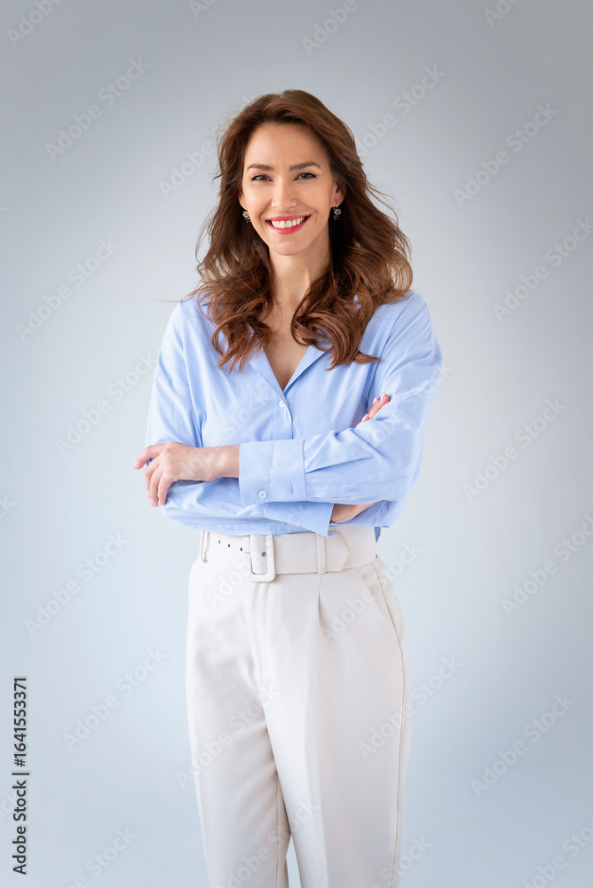 Studio shot of a brunette haired woman standing against isolated background wiht copy space Studio shot of a brunette haired woman standing against isolated background wiht copy space