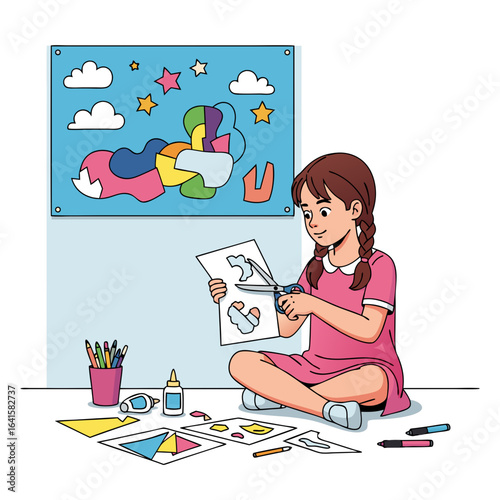 Creative girl with red pigtails in a pink dress sitting crosslegged while cutting paper shapes for an art project.