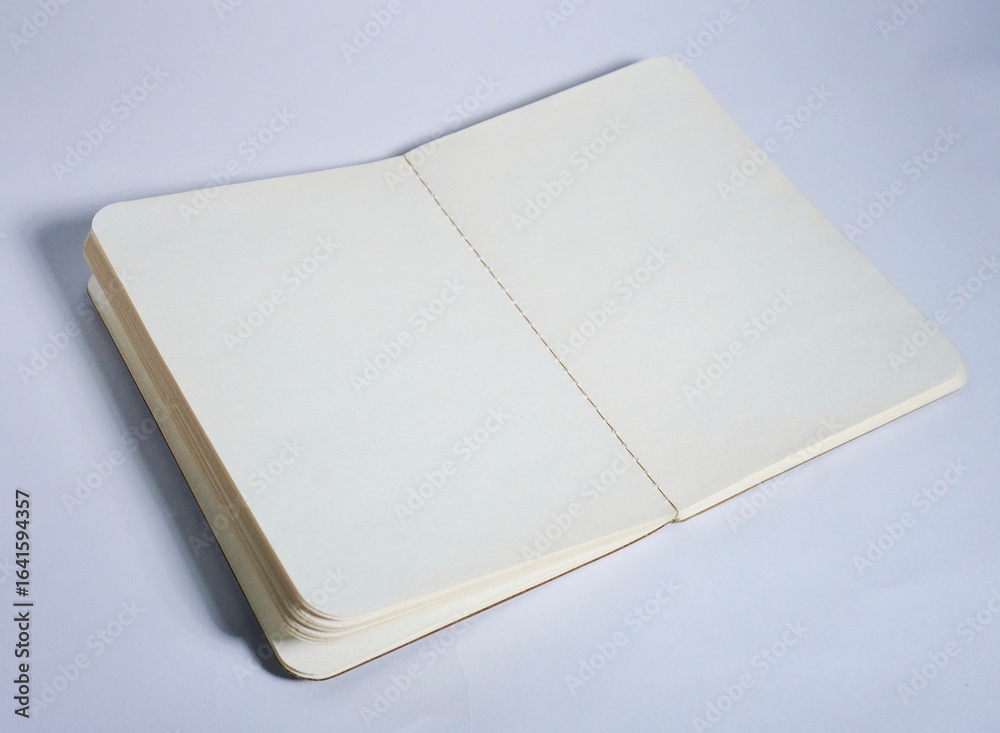 Fototapeta premium Opened empty book with white plain paper isolated on horizontal copy spaced white background.