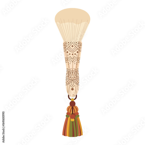 Makeup brush with decorative handle and tassel hanging from the bottom.