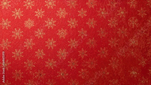 Full frame image of red seasonal wrapping paper with a repeating design of gold snowflakes