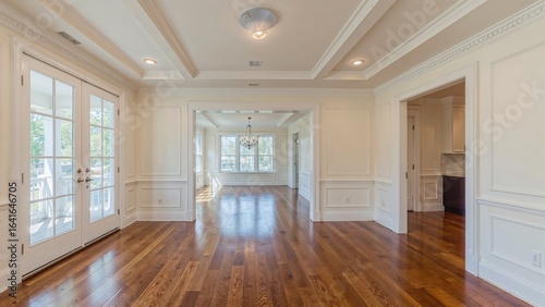 Recently remodeled space showcasing painted ceilings, refined wood flooring, and elegant moldings.