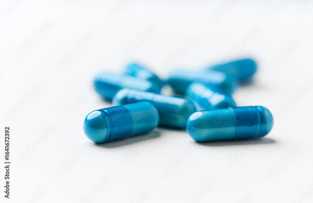 Amino acids capsules on bright background. Soft focus. Close up. Copy space. Amino acids capsules on bright background. Soft focus. Close up. Copy space.