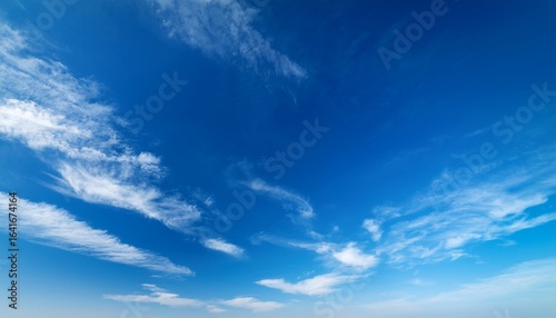 a serene scene of clear blue skies with wispy white clouds peacefully drifting in the airy atmosphere creating a tranquil copy space image